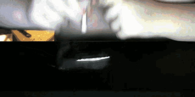 a close up of a person 's hand holding a piece of paper