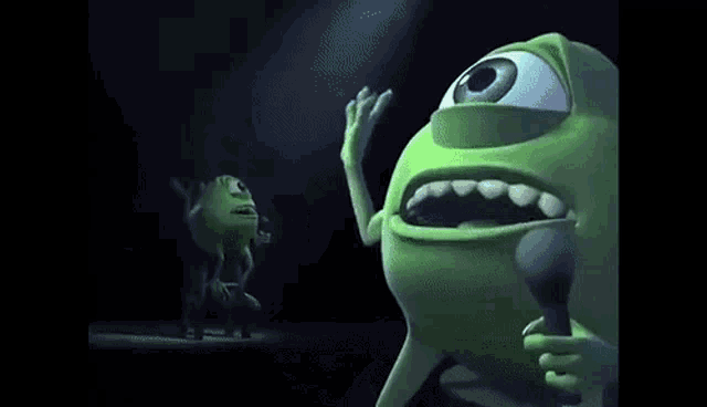 mike from monsters inc is holding a microphone in his hands .