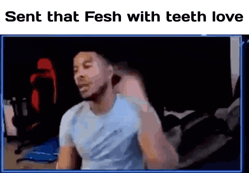 a man is sitting in front of a computer screen with the words sent that fsh with teeth love on the bottom .