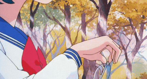 a girl in a school uniform is holding a pair of glasses in her hand .