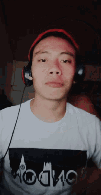 a man wearing headphones and a t-shirt that says london