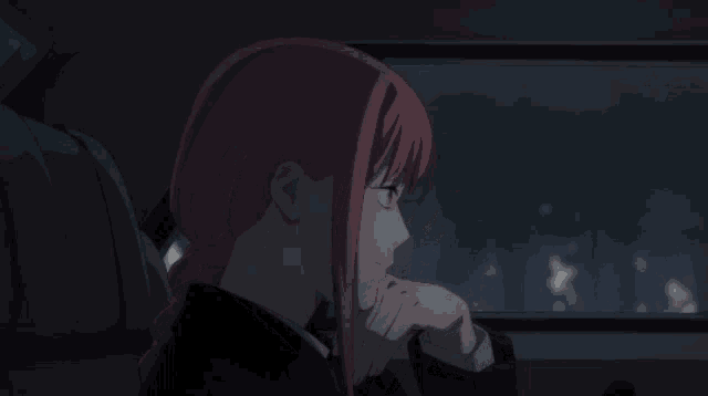 a girl with red hair and red eyes is sitting in a car