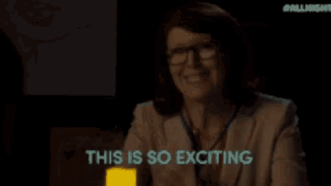 a woman with glasses is smiling and says this is so exciting