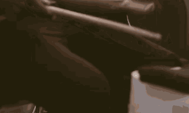 a close up of a person 's hand holding a piece of paper in a car .