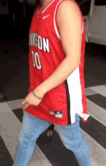a man wearing a red jersey with division 10 on it