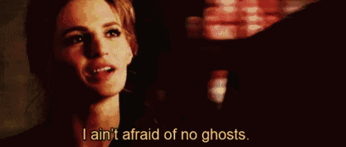 a woman is talking to a man and says `` i ain 't afraid of no ghosts '' .