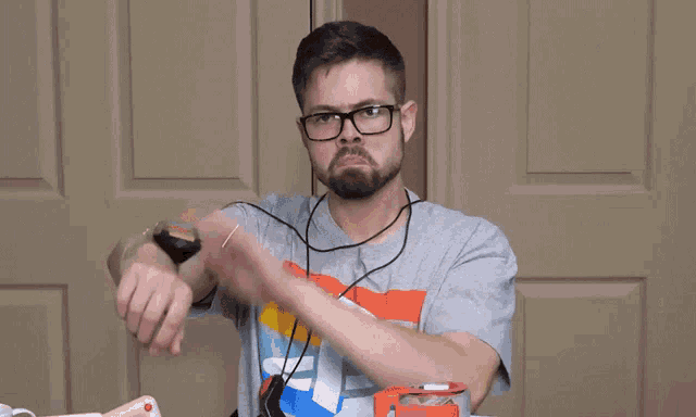 a man wearing glasses and a yup t-shirt