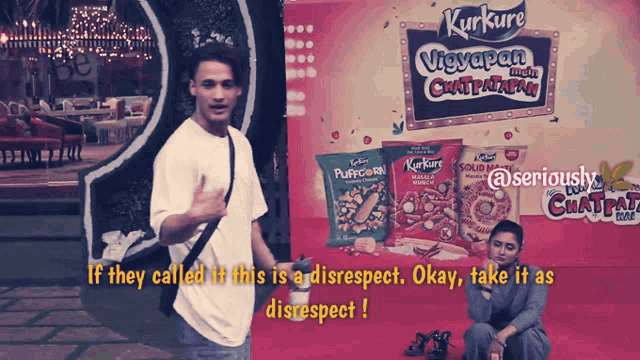 a man is standing in front of an advertisement for kurkure chips
