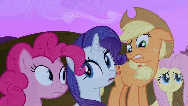 a group of ponies are standing next to each other looking at something