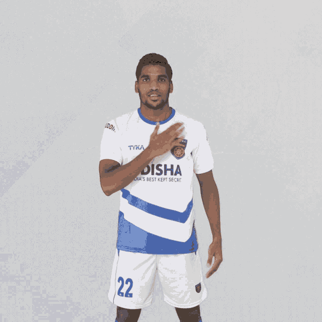 a soccer player wearing a white and blue jersey that says odisha india 's best kept secret