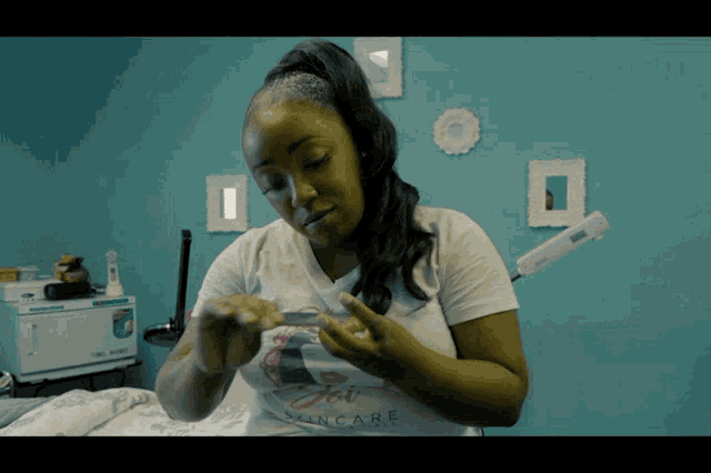 a woman wearing a shirt that says jet skincare looks at something