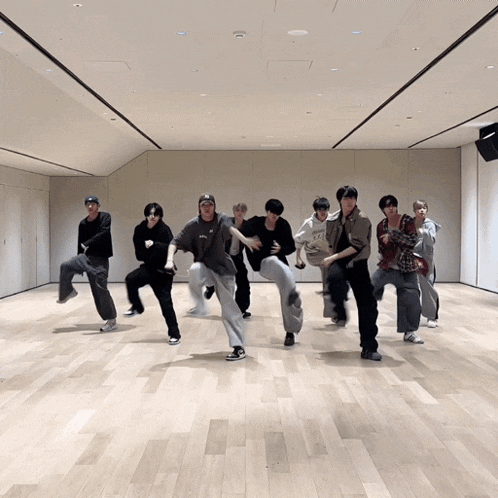 a group of people are dancing in a room and one of them is wearing a shirt that says ' gucci '