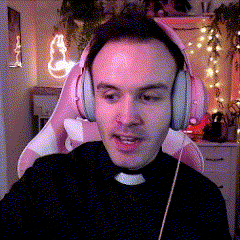 a man wearing pink headphones sitting in a pink chair