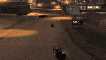 a person riding a motorcycle down a street with a cross on the sidewalk