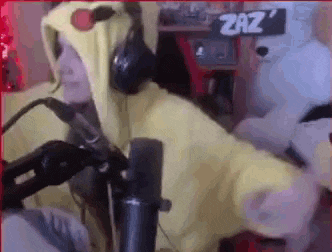a person in a chicken costume is standing in front of a microphone .