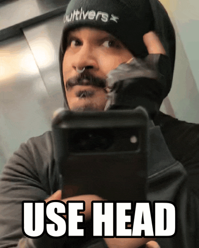 a man taking a picture of himself with the words use head on the bottom