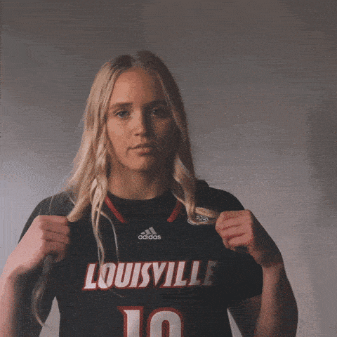 a woman wearing a black louisville jersey