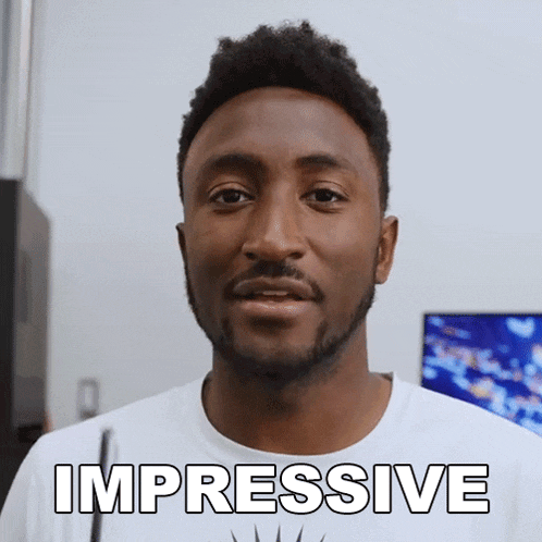 a man with a beard is wearing a white shirt with the word impressive on it