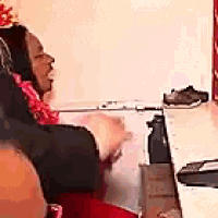 a woman wearing a party hat is sitting at a table with a computer mouse .