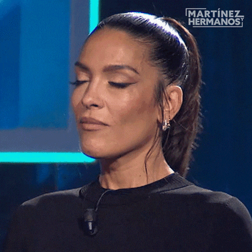 a woman with her eyes closed and a martinez hermanos logo in the background