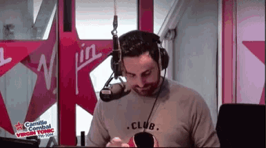 a man is wearing headphones and a shirt that says club on it