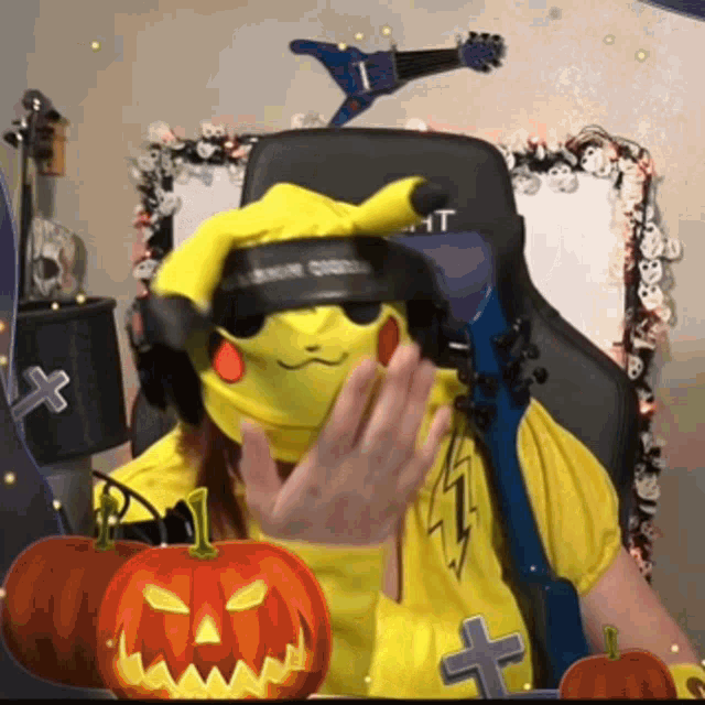a person wearing a pikachu costume with headphones and a guitar