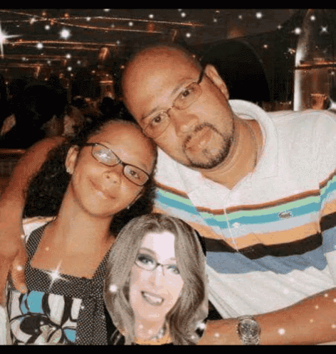 a man and a woman are posing for a picture with a picture of a woman on the man 's arm .