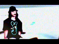 a man wearing a mickey mouse t-shirt is standing in front of a white wall