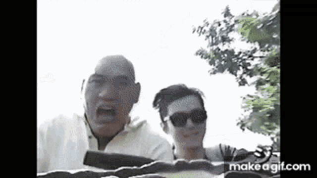 a man and a woman are riding a roller coaster at a theme park .
