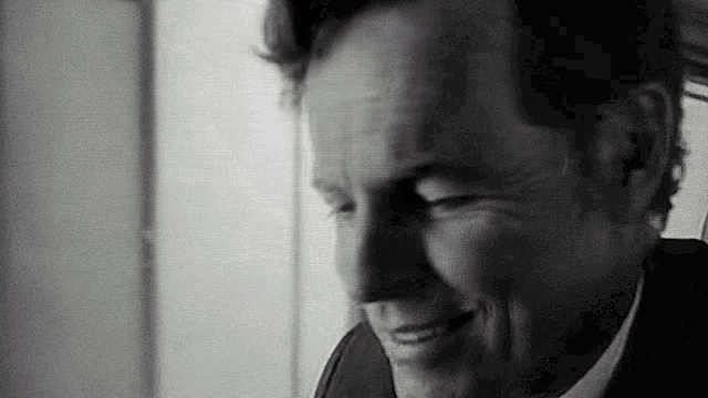 a close up of a man 's face with a smile on his face