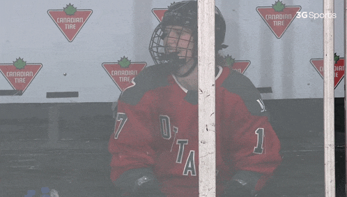 a hockey player wearing a red jersey that says otta on it