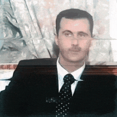 a man in a suit and tie has a blurred image of his face