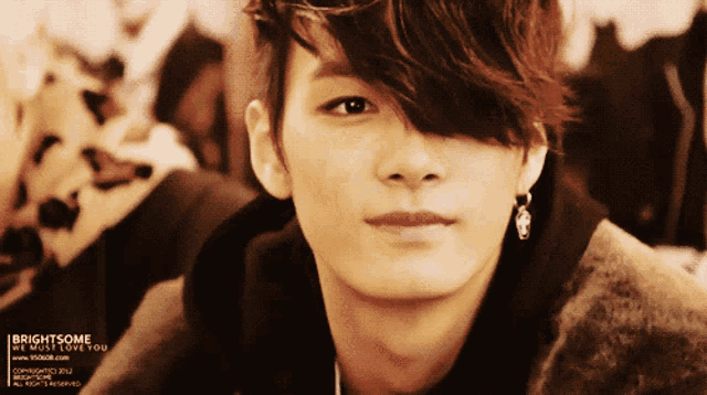 a close up of a man 's face with the words brightsome we must love you