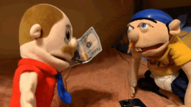 a puppet with a cigarette in his mouth holds a 100 dollar bill in front of another puppet