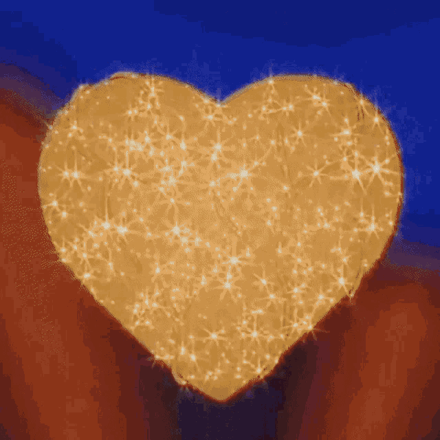 a heart made of sparkles on a blue and red background
