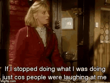 a woman in a red jacket is standing in front of a door and saying if i stopped doing what i was doing