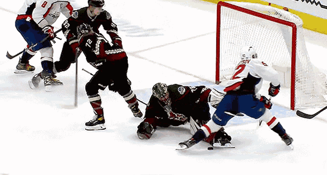 a hockey game is being played and the goalie has the number 2 on his jersey
