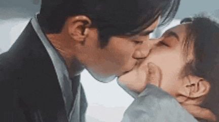 a man and a woman are kissing each other .