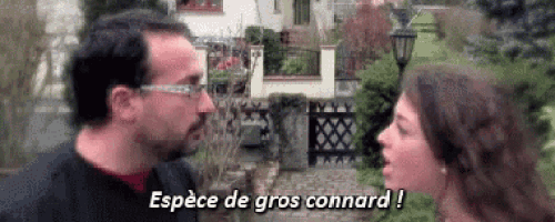 a man and a woman are talking to each other in front of a house and the woman is saying espèce de gros connard !