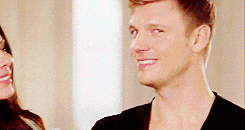 a man and a woman are standing next to each other and the man is smiling