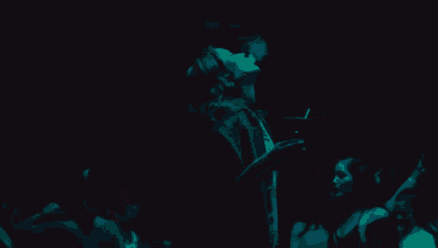 a woman is smoking a cigarette while holding a drink in her hand