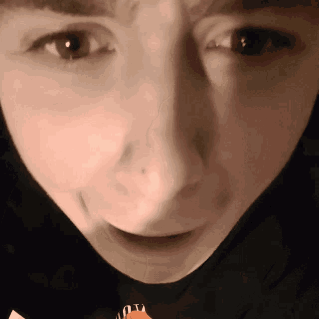 a close up of a person 's face with a t-shirt that says aoy on it