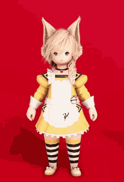 a little girl wearing a yellow dress with a white apron has the letter k on it