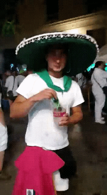 a man wearing a sombrero and a coca cola bottle