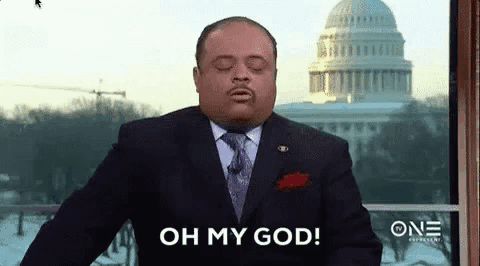 a man in a suit and tie is saying oh my god .