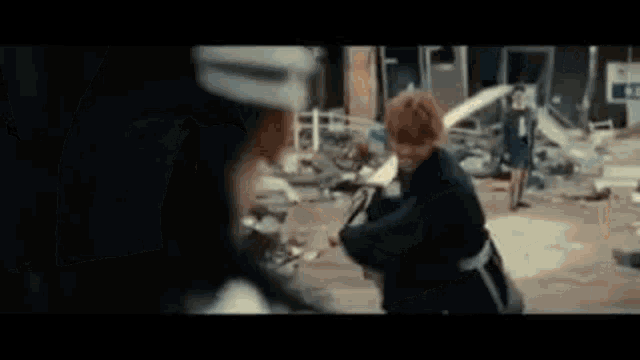 a woman with red hair is walking down a street in a blurred image .