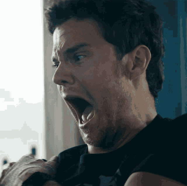 a man making a funny face with his mouth wide open