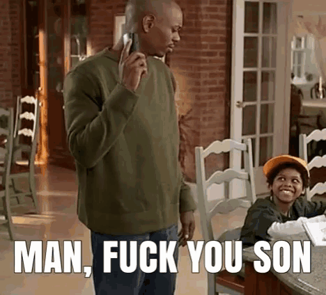 a man is talking on a cell phone while standing next to a boy who is smiling .