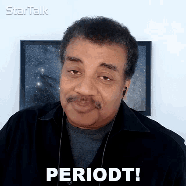 a man with a mustache is wearing earbuds and says periodt