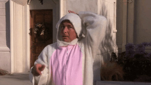 a man wearing a pink and white bunny costume